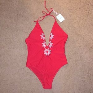 Red halter one piece bathing suit.